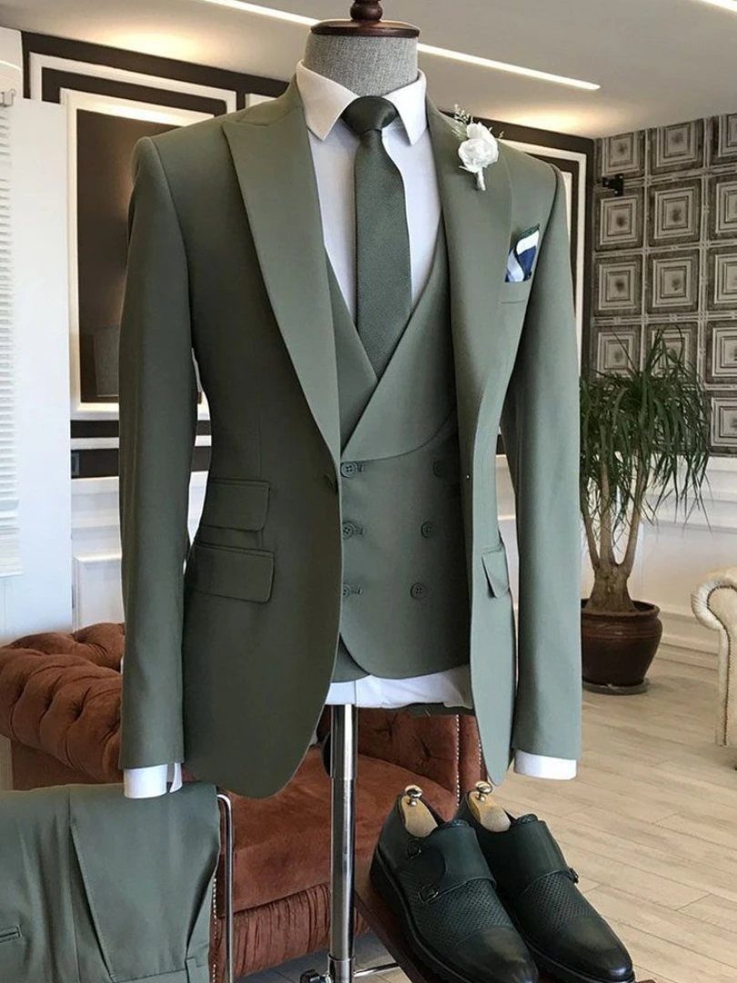 An olive green three-piece suit with a double-breasted waistcoat displayed on a mannequin.