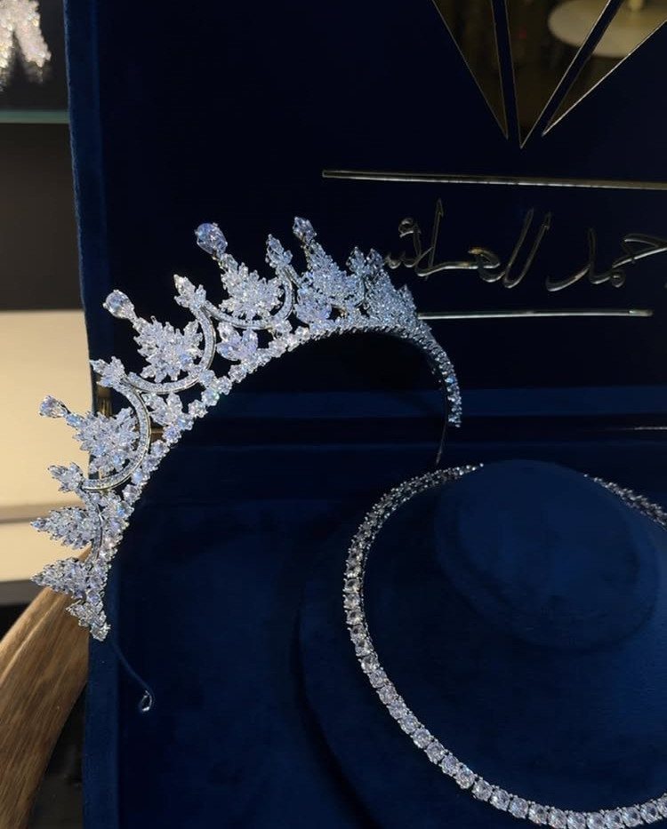 11 Bridal Diamond Necklace Ideas for Your Ceremony 11 A sparkling diamond tiara and matching necklace resting in a blue velvet jewelry box.
