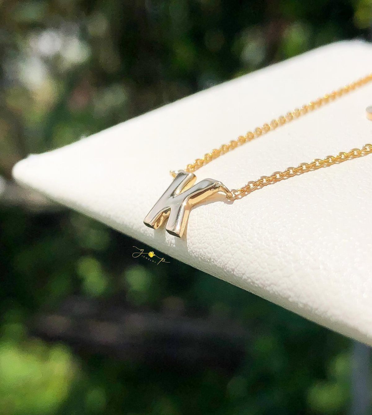Bridesmaid Jewelry Gold: 10 Ideas for Every Wedding Style 4 Gold necklace featuring a single letter K pendant resting on a white display stand.