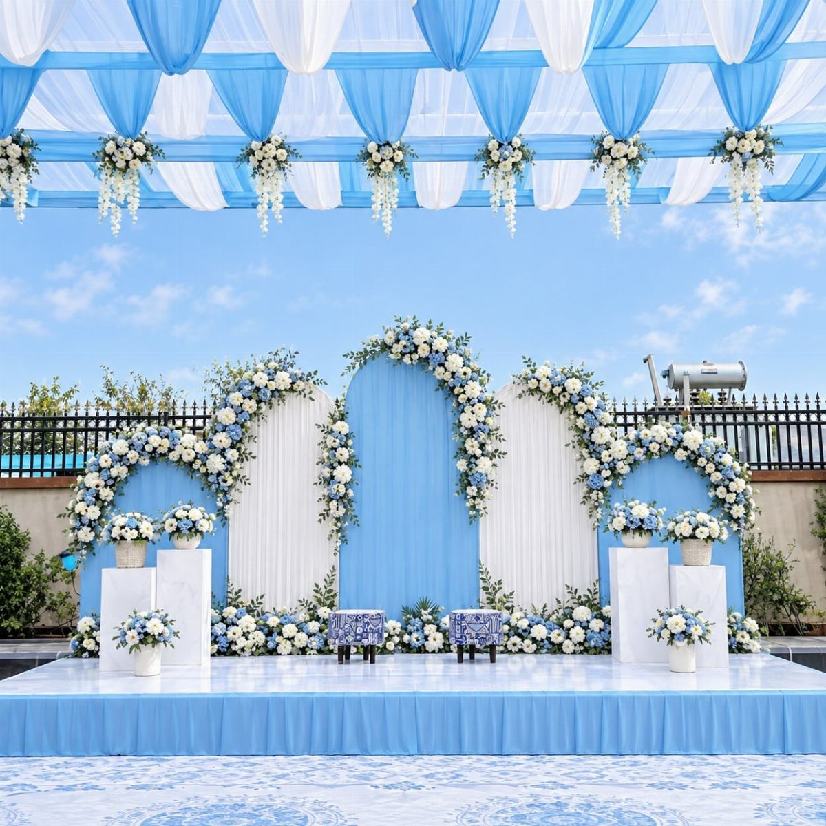 Light Blue Wedding: 8 Ideas From Cake to Tulle Runner 6 A large wedding stage with light blue and white backdrops adorned with white and blue flowers.