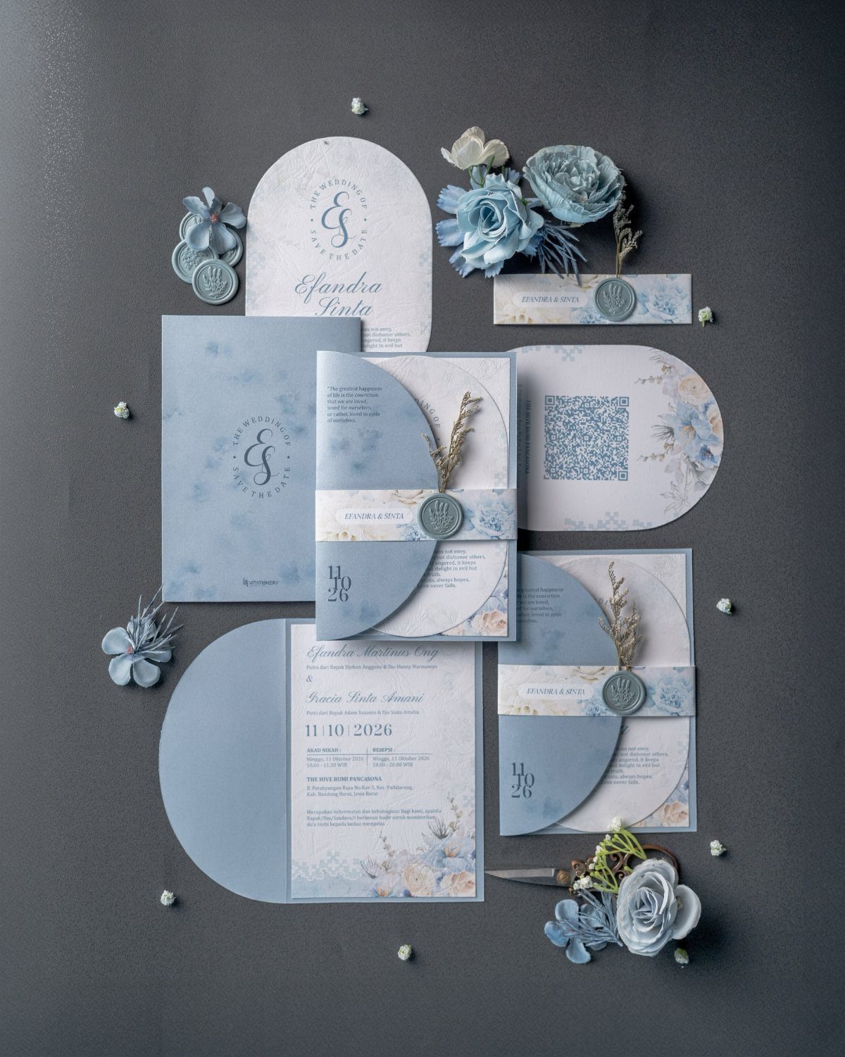 Light Blue Wedding: 8 Ideas From Cake to Tulle Runner 3 Light blue wedding invitations and stationery arranged with blue flowers and wax seals on grey background.