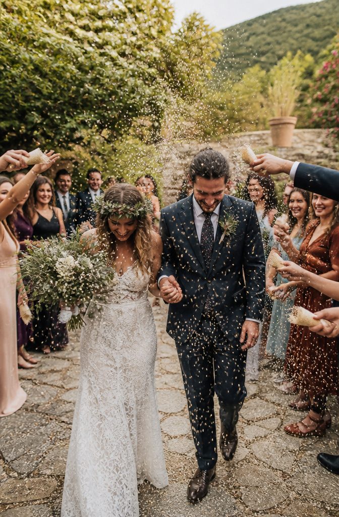 Pagan Wedding Traditions: Handfasting, Offerings and Ceremony Rituals 11 Guests throw rice into the air as the couple leaves the ceremony.