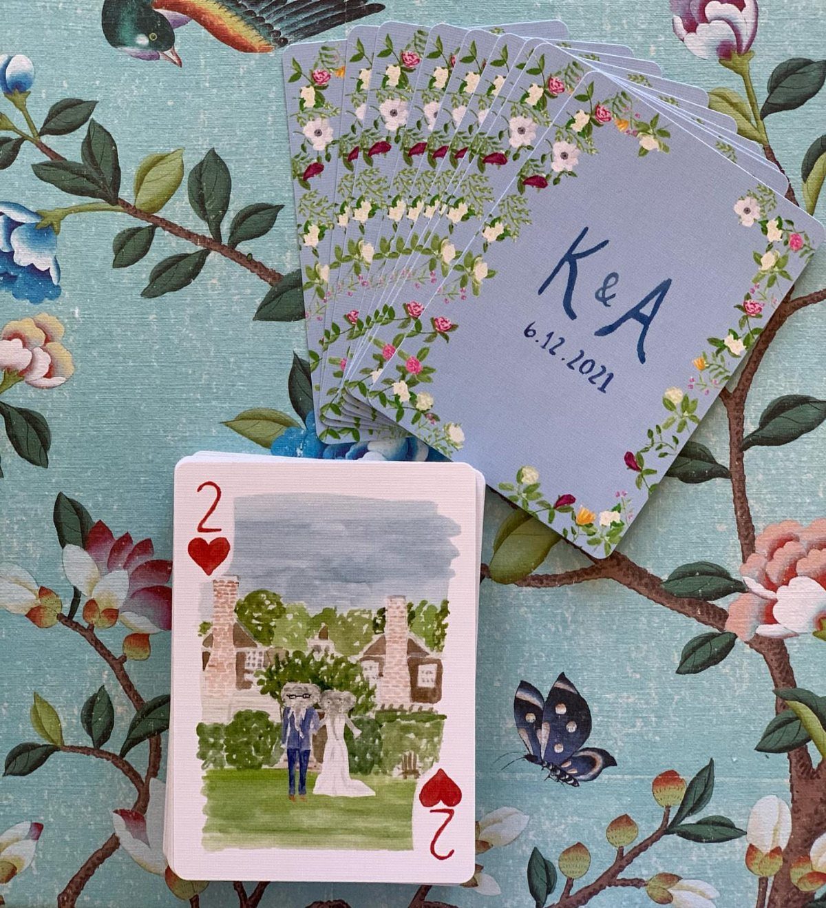 10 Wedding Favors for Guests Ideas: From Plants to Hot Sauce 7 Custom playing cards with floral designs and a watercolor illustration of a wedding couple.