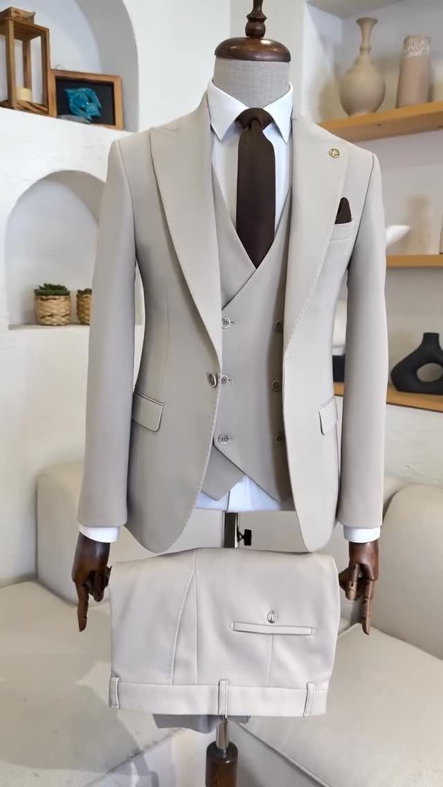 Wedding Suits for Men: 12 Groom Looks Outside Black Tie 6 A beige three-piece men's suit with a brown tie displayed on a wooden mannequin.