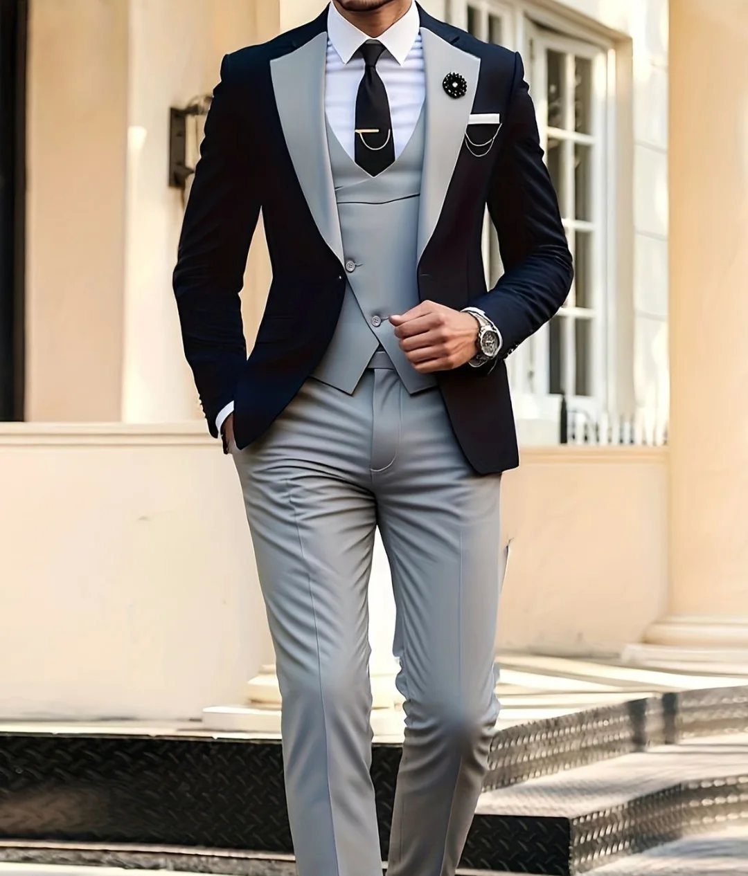 Wedding Suits for Men: 12 Groom Looks Outside Black Tie 8 Man wearing a stylish navy and light grey three-piece wedding suit with a black tie.