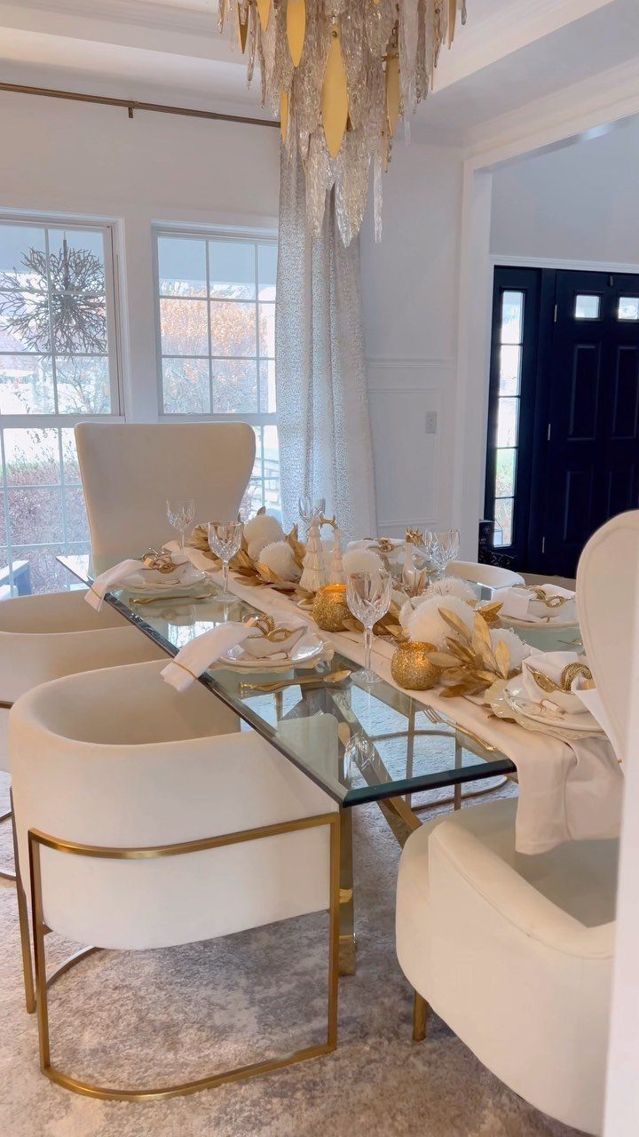 White Wedding Decorations: 10 Ideas for an Elegant Celebration 9 A glass dining table set with white plates, gold cutlery, and a white fabric runner.