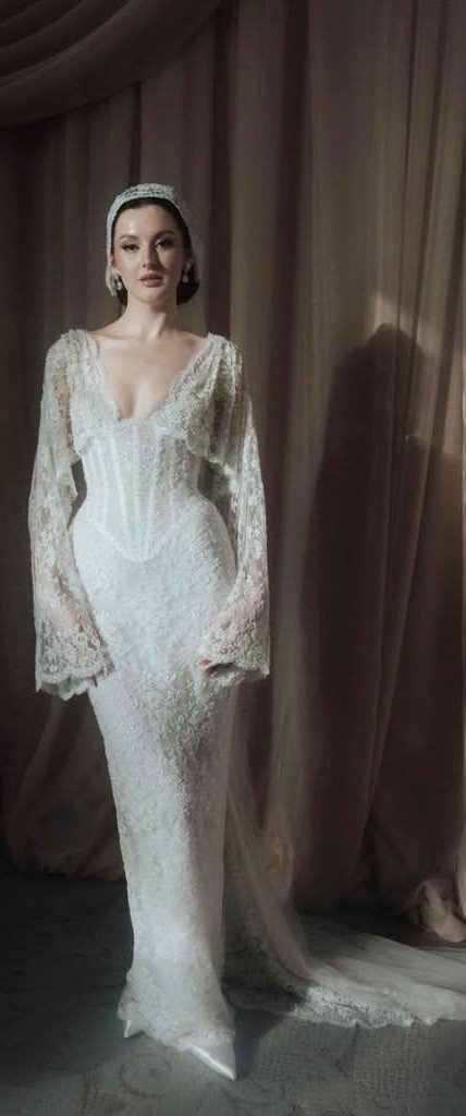 7 Enchanting Ideas for Witchy Wedding Dresses 6 Woman wearing an ivory lace mermaid wedding dress with long sleeves and a headband.